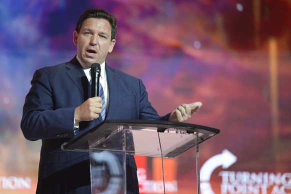 FILE - Florida Gov. Ron DeSantis addresses attendees during the Turning Point USA Student Action Summit, July 22, 2022, in Tampa, Fla. Florida Gov. Ron DeSantis, who likely represents former President ...