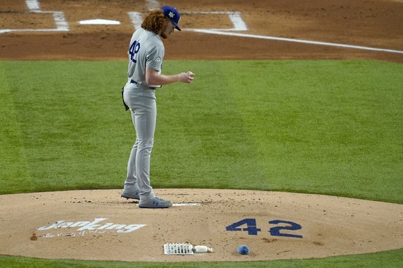 Los Angeles Dodgers starting pitcher Dustin May pauses on the mound before throwing to the Texas Rangers in the first inning of a baseball game in Arlington, Texas, Friday, Aug. 28, 2020. The number 4 ...