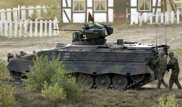 FILE -- Soldiers follow a Marder infantry fighting vehicle during a demonstration event held for the media by the German Bundeswehr in Bergen near Hannover, Germany, Wednesday, Sept. 28, 2011. U.S. Pr ...