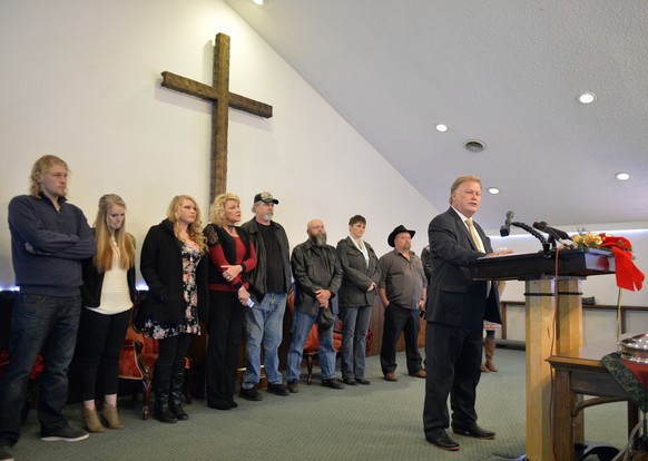 With friends and family standing behind him, Kentucky State Rep., Republican Dan Johnson addresses the public from his church on Tuesday, Dec. 12, 2017, regarding allegations that he sexually abused a ...