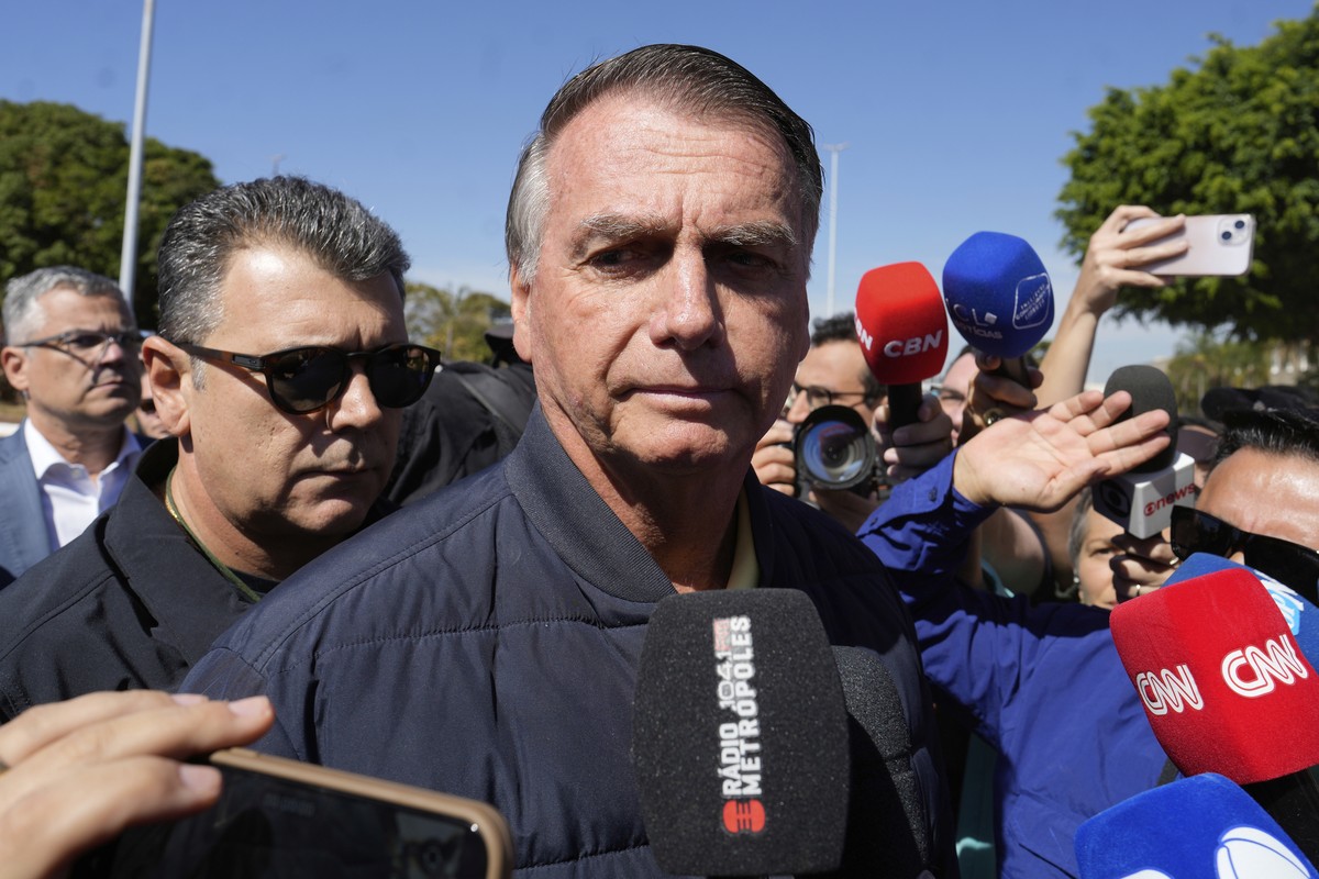 Brazil's former President Jair Bolsonaro speaks to the press outside the Secretariat of Penitentiary Administration where he arrived after the Supreme Court ordered him to be fitted with an elect ...