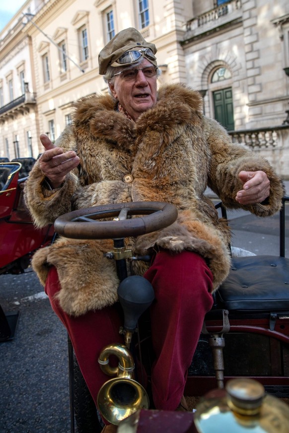 St Jamess Motoring Spectacle in London, UK - 01 Nov 2025 A gentleman wearing traditional driving clothes sits in a vintage car during a show. Thousands of people gathered on Pall Mall in Central Londo ...