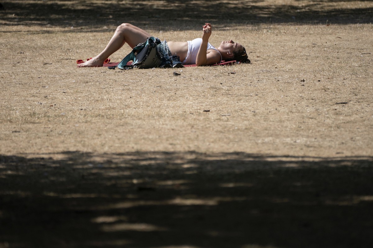 A woman sunbathes in St James's Park, London, Tuesday July 19, 2022. Britain shattered its record for highest temperature ever registered Tuesday, with a provisional reading of 39.1 degrees Celsi ...