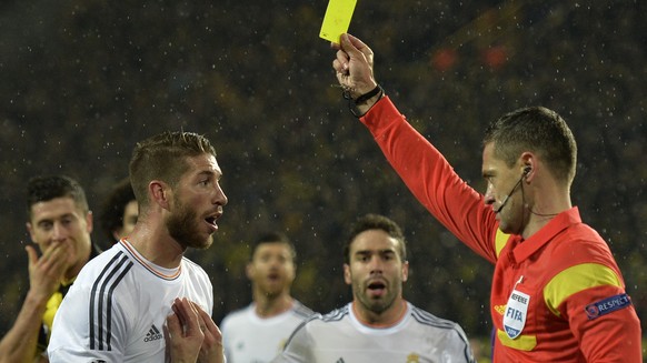 Real&#039;s Sergio Ramos gets a yellow card from referee Damir Skomina during the Champions League quarterfinal second leg soccer match between Borussia Dortmund and Real Madrid in the Signal Iduna st ...