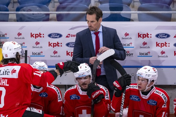 Switzerland&#039;s head coach Patrick Fischer, back, during an ice hockey World Cup preparation match between Switzerland and France at the St. Jakob-Arena in Basel, Switzerland, on Friday, April 19,  ...