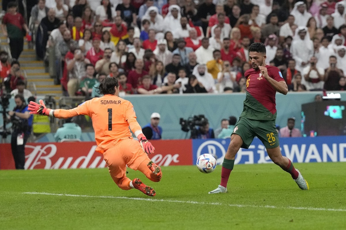 Portugal's Goncalo Ramos, right, scores his side's fifth goal during the World Cup round of 16 soccer match between Portugal and Switzerland, at the Lusail Stadium in Lusail, Qatar, Tuesday, ...