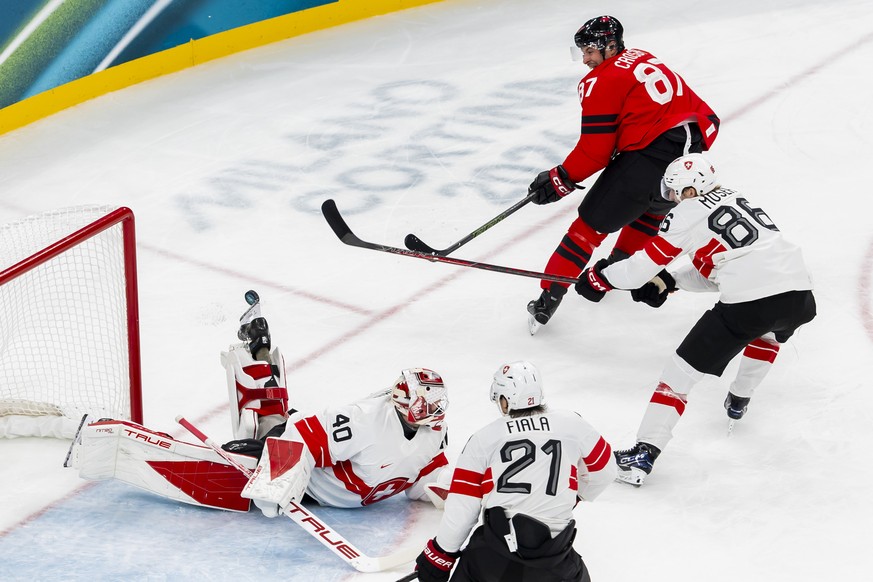 Switzerland's goaltender Akira Schmid #40 saves a shot from Canada's Sidney Crosby #87, during the men's group A preliminary round game between Canada and Switzerland at the 2026 Olympi ...