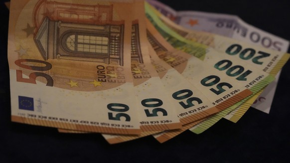 FILE - Euro banknotes lie on a table in Munich, Germany, on March 30, 2022. Inflation in Europe soared to another record, a fresh sign that rising energy prices fueled by Russia