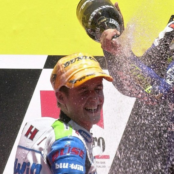 Winner Spanish Daniel Pedrosa (R) celebrates with second placed Swiss Thomas Luethi after winning the 125 cc race of the Catalonian Motorcycle Grand Prix at the Montmelo Circuit in Barcelona, on Sunda ...