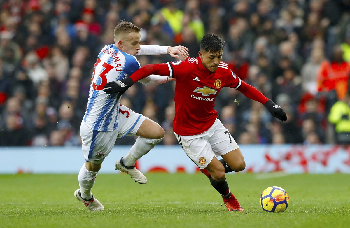 Huddersfield Town's Florent Hadergjonaj, left, and Manchester United's Alexis Sanchez during their English Premier League soccer match at Old Trafford in Manchester, England, Saturday Feb. 3 ...