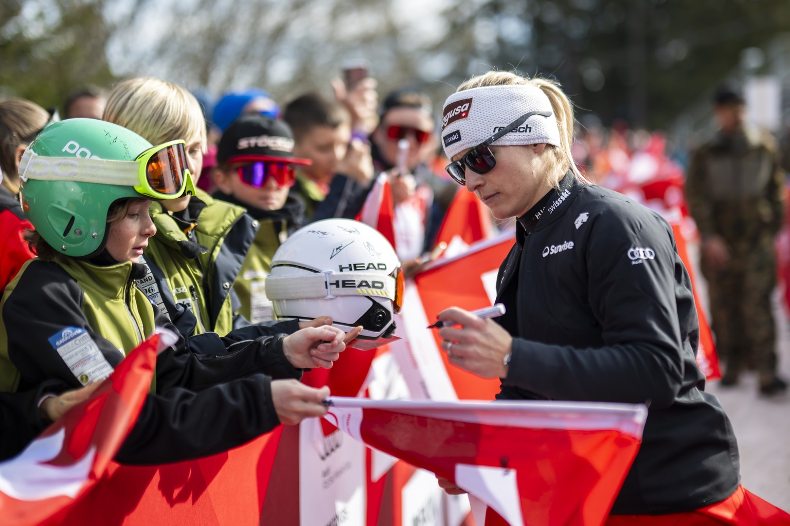 Lara Gut-Behrami of Switzerland writes autographs to fans during the women&#039;s Downhill race at the Alpine Skiing FIS Ski World Cup, in Crans-Montana, Switzerland, Friday, February 16, 2024. (KEYST ...