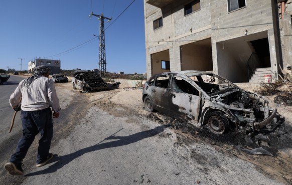 epa13149280 People inspect damaged cars after an attack by Israeli settlers in the village of Jalud, near the West Bank city of Nablus, 04 August 2026. According to the Wafa news agency, Israeli settl ...