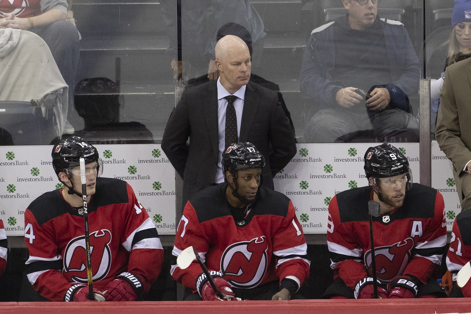 New Jersey Devils coach John Hynes, center, watches the team play the New York Rangers during the third period of a preseason NHL hockey game Friday, Sept. 20, 2019, in Newark, N.J. (AP Photo/Mary Alt ...