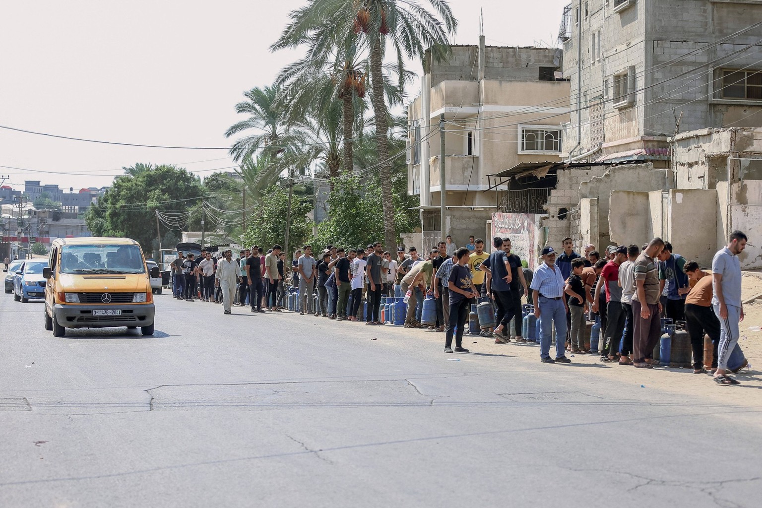 Humanitarian Catastrophe Looms After Israeli Attacks - Gaza People line up for hours, waiting to refill their propane tanks after Israeli airstrikes. Gaza, October 14, 2023. After eight days of relent ...