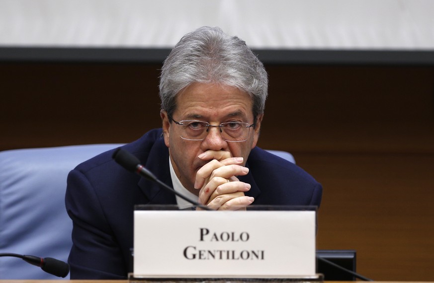 Italian Premier Paolo Gentiloni sits before the start of the traditional year-end press conference in Rome, Thursday Dec. 28, 2017. (AP Photo/Domenico Stinellis)