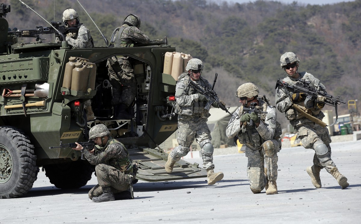 U.S. Army soldiers from the 25th Infantry Division’s 2nd Stryker Brigade Combat Team and South Korean soldiers take their position during a demonstration of the combined arms live-fire exercise as a p ...