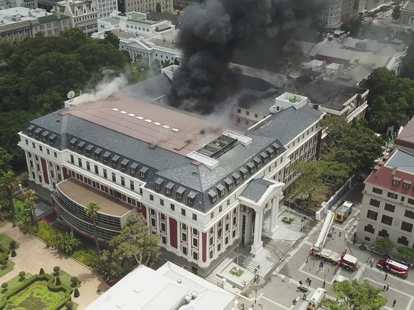 This photo supplied by the City of Cape Town shows smoke rising from the Houses of Parliament, in Cape Town, South Africa, Sunday, Jan. 2, 2022. Firefighters are still working at the Parliament comple ...