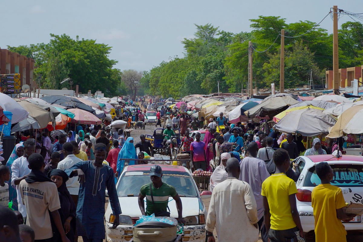 Pedestrian shops at a market in Niamey, Niger, Wednesday, July. 24, 2024. One year has passed since a dramatic coup in Niger. (AP Photo/Omar Hama)