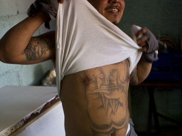A member of the gang Mara Salvatrucha, MS, shows his tattoo inside the San Pedro Sula prison in Honduras, Tuesday, May 28, 2013. Honduras&#039; largest and most dangerous street gangs have declared a  ...