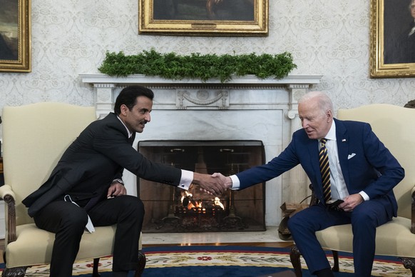 President Joe Biden, right, shakes hands with the Qatar&#039;s Emir Sheikh Tamim bin Hamad Al Thani in the Oval Office of the White House, Monday, Jan. 31, 2022, in Washington. (AP Photo/Alex Brandon) ...