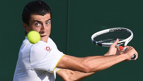 epa06066198 Sebastian Ofner of Austria returns to Thomaz Bellucci of Brazil in their first round match during the Wimbledon Championships at the All England Lawn Tennis Club, in London, Britain, 04 Ju ...