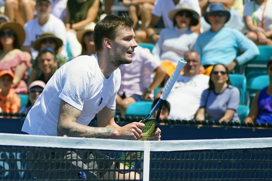 Alexander Bublik of Kazakhstan attempts to hit a shot from Casper Ruud of Norway with the handle of his racquet, at the Miami Open tennis tournament, Sunday, March 27, 2022, in Miami Gardens, Fla. (AP ...