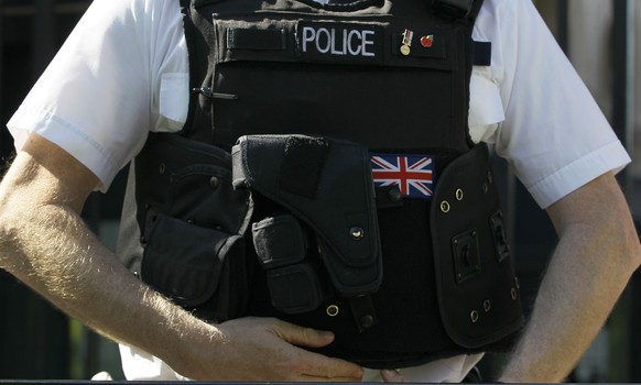 FILE - A police officer keeps watch in Westminster, in London, on March 28, 2012. New and expanded powers for British police took effect on Sunday, July 2, 2023, including measures targeting activists ...