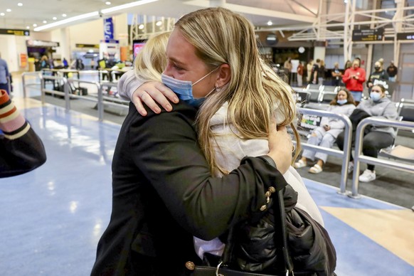 Families embrace after a flight from Los Angeles arrived at Auckland International Airport as New Zealand&#039;s border opened for visa-waiver countries Monday, May 2, 2022. New Zealand welcomed touri ...