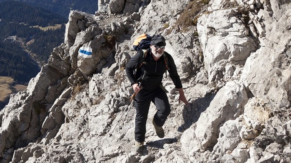 A mountain hiker climbs up an alpine mountain trail above Seewis in the canton of Grisons' Praettigau region, Switzerland, across the rocky, southern mountainside of Mount Schesaplana on 2'9 ...