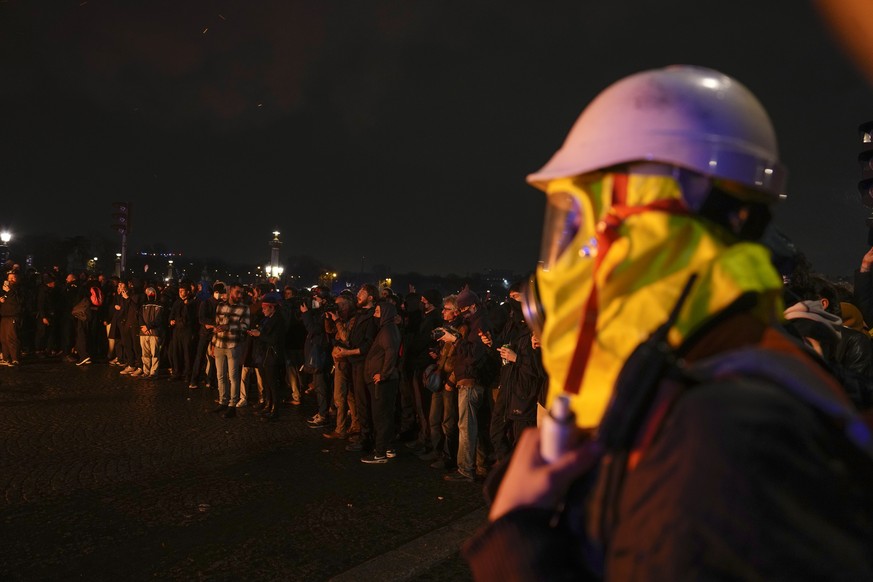 Demonstrators stage a protest in Paris, Friday, March 17, 2023. Protests against French President Emmanuel Macron&#039;s decision to force a bill raising the retirement age from 62 to 64 through parli ...