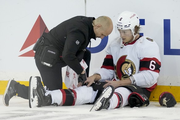 Ottawa Senators defenseman Jakob Chychrun (6) sits on the ice with an apparent injury after a collision with New York Rangers center Filip Chytil (72) during the third period of an NHL hockey game, Th ...