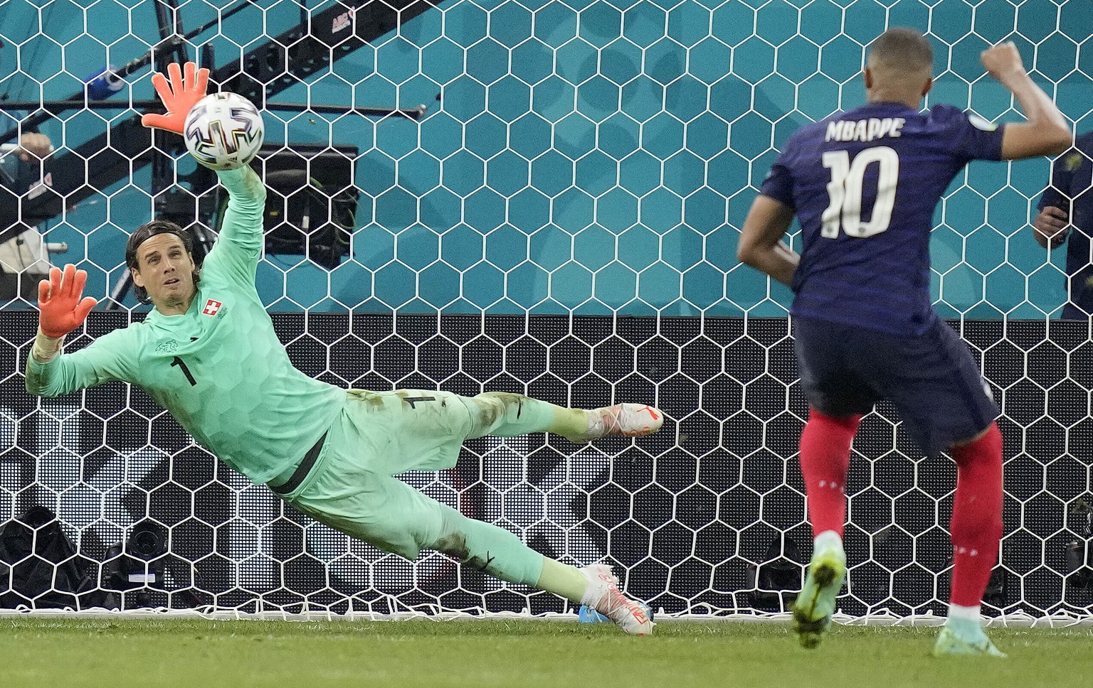 Switzerland&#039;s goalkeeper Yann Sommer saves the penalty shot by France&#039;s Kylian Mbappe during the Euro 2020 soccer championship round of 16 match between France and Switzerland at the Nationa ...