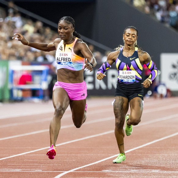 The winner Julien Alfred of Saint Lucia, center, crosses the finish line next to Amy Hunt of United Kingdom, left, and Sha'Carri Richardson of United States, right, during the women's 100 me ...