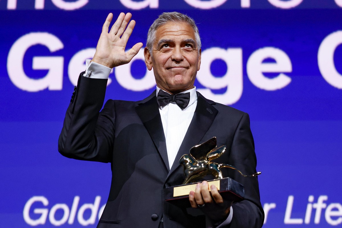 epa13207469 US actor George Clooney holds the Golden Lion Lifetime Achievement Award during the opening ceremony at the 83rd annual Venice International Film Festival, in Venice, Italy, 02 September 2 ...