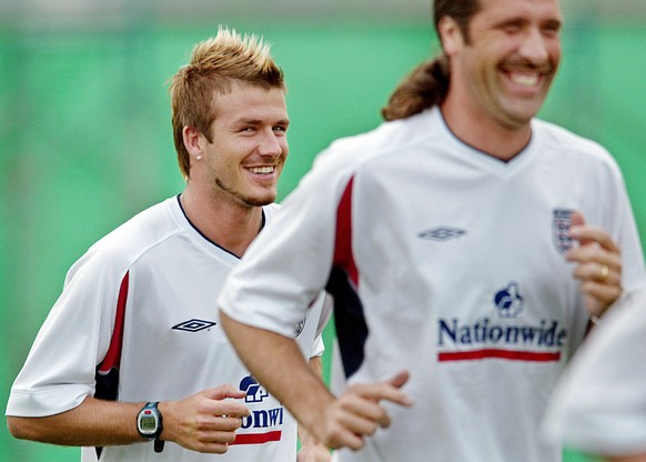 WW01 - 20020608 - KOBE, JAPAN : England captain David Beckham (L) and goalkeeper David Seaman (R) share a laugh after they go through a light training run on the island of Awaji near the port city of  ...