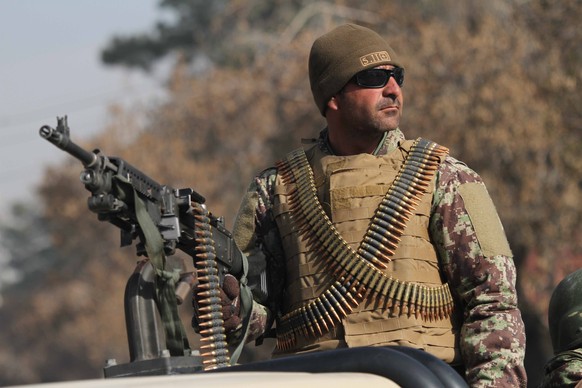 epa08996382 An Afghan security official stands guard during a rally to support Afghan security forces and demand peace in the country in Herat, Afghanistan, 08 February 2021. Hamdullah Mohib, Afghanis ...