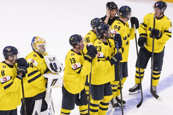 Sweden's players show dejection after their defeat in the 2026 IIHF Men's Ice Hockey World Championship preliminary round group B game between Norway and Sweden, at the BCF Arena ice hockey  ...