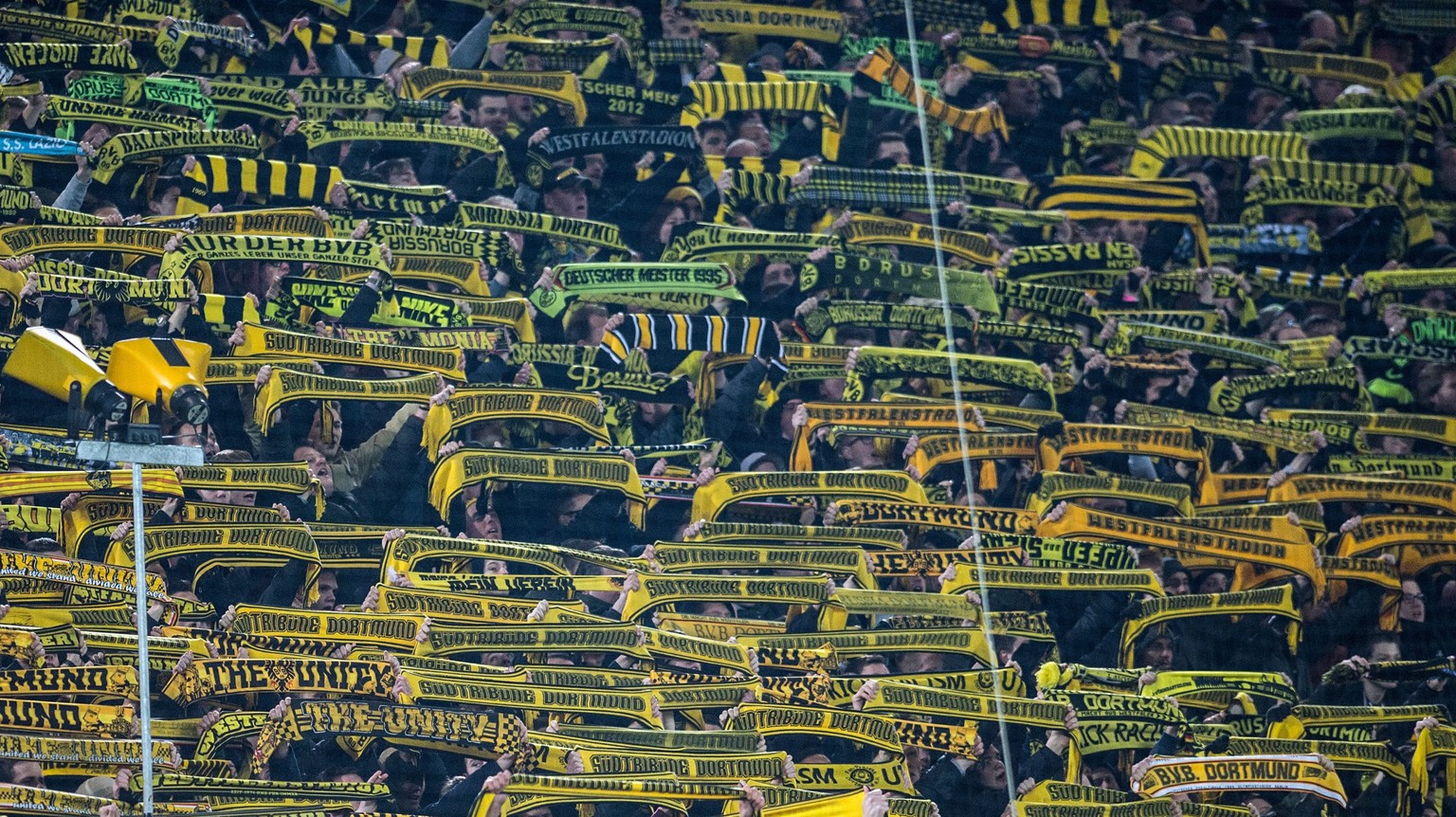 epa05209947 Dortmund fans hold up their scarves and sing &#039;You never walk alone&#039; for a fan who died of a heart attack during the German Bundesliga soccer match between Borussia Dortmunand FSV ...