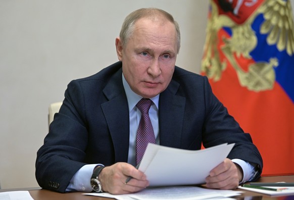 Russian President Vladimir Putin attends a cabinet meeting via video conference at the Novo-Ogaryovo residence outside Moscow, Russia, Friday, Dec. 24, 2021. (Alexei Nikolsky, Sputnik, Kremlin Pool Ph ...