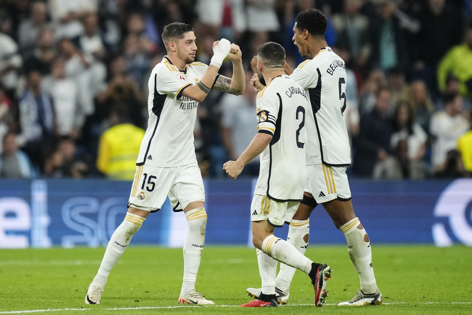 Real Madrid&#039;s Federico Valverde, left, is congratulated after scoring his side&#039;s opening goal during Spanish La Liga soccer match between Real Madrid and Real Sociedad at the Santiago Bernab ...