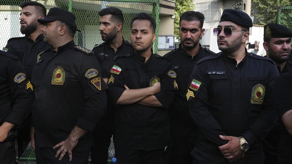 Iranian police officers stand guard during a protest against Sweden in front of the Swedish Embassy in Tehran, Iran, Friday, July 21, 2023. Thousands of people took to the streets in a handful of Musl ...