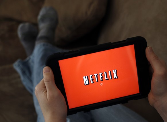 FILE - In this Friday, Jan. 17, 2014, file photo, a person displays Netflix on a tablet in North Andover, Mass. From Netflix, Spotify and Amazon Prime to Blue Apron, Birchbox and beer of the month, yo ...