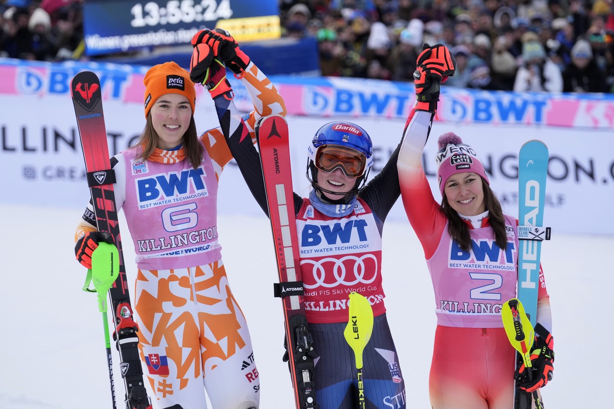 Mikaela Shiffrin, of the United States, celebrates her victory in a women's World Cup slalom skiing race with second place finisher Petra Vlhova, of Slovakia, left, and third place Wendy Holdener ...