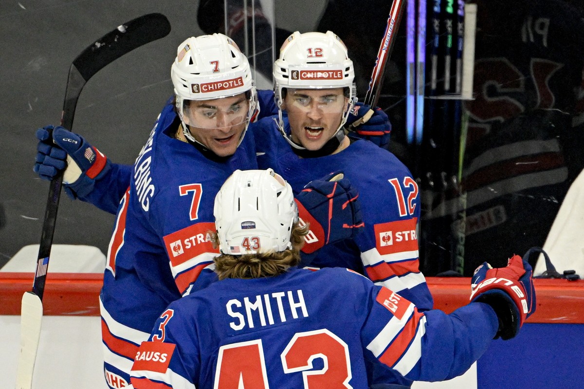 epa12126337 USA's Shane Pinto (#12) celebrates with Michael Kesselring (#7) and Will Smith (#43) after scoring the team's fourth goal (4-2) during the 2025 IIHF Ice Hockey World Championship ...