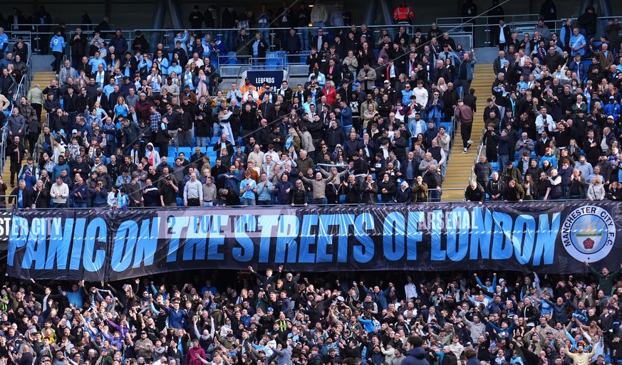 Manchester City fans hold up a banner after the English Premier League soccer match between Manchester City and and Arsenal, in Manchester, England, Sunday, April 19, 2026. (Martin Rickett/PA via AP)
 ...