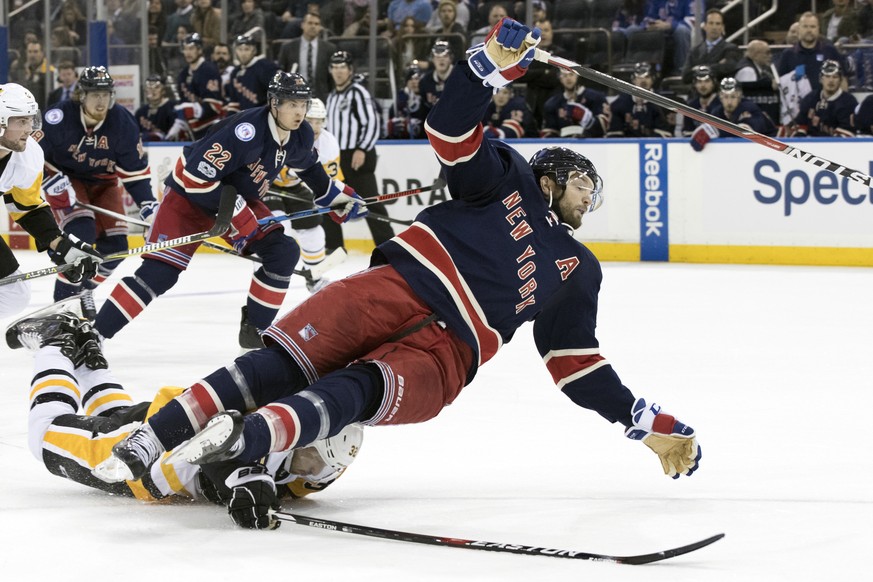 Pittsburgh Penguins defenseman Mark Streit, bottom, trips New York Rangers right wing Rick Nash during the second period of an NHL hockey game, Friday, March 31, 2017, at Madison Square Garden in New  ...