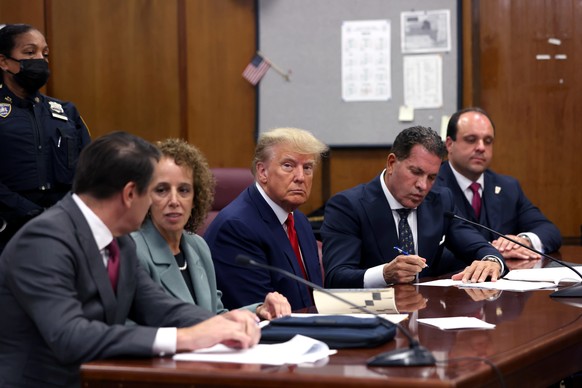 epa10558828 Former US President Donald J. Trump (C) appears in the New York Criminal Court in New York, New York, USA, 04 April 2023. A Manhattan grand jury voted to indict former President Donald J.  ...