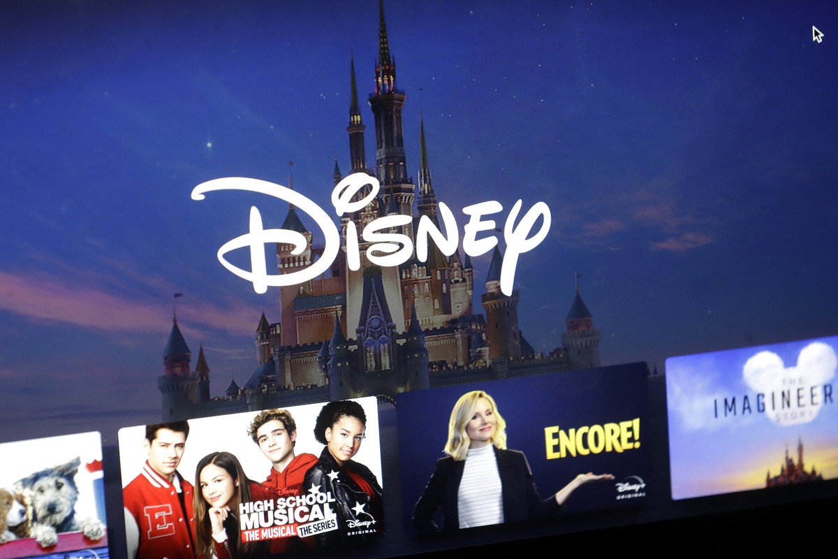 FILE - In this Wednesday, Nov. 13, 2019 file photo, a Disney logo forms part of a menu for the Disney Plus movie and entertainment streaming service on a computer screen in Walpole, Mass. Analysts pre ...