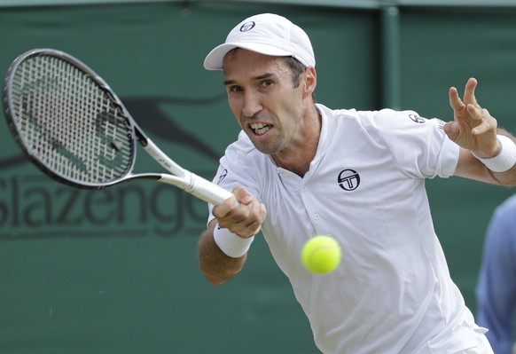 Kazakhstan&#039;s Mikhail Kukushkin returns the ball to Japan&#039;s Kei Nishikori in a men&#039;s singles match during day seven of the Wimbledon Tennis Championships in London, Monday, July 8, 2019. ...