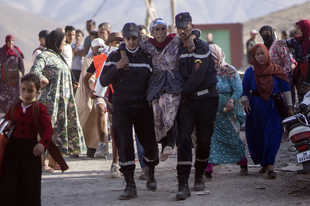 Rescue workers carry a woman who was injured by an aftershock, in the town of Imi N'tala, outside Marrakech, Morocco, Wednesday, Sept. 13, 2023. An aftershock rattled central Morocco on Wednesday ...